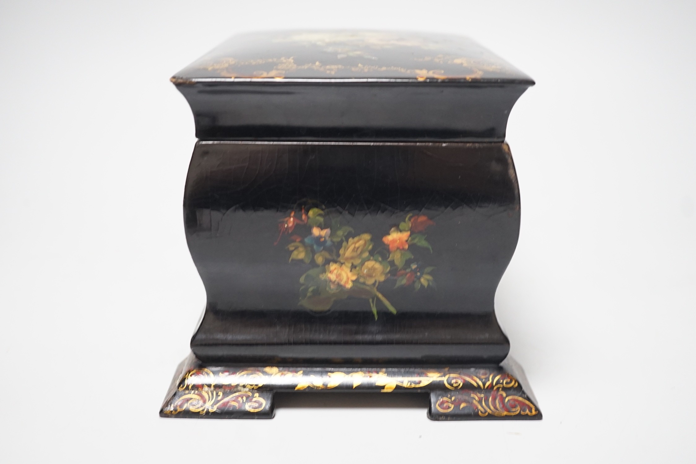 A Victorian papier-mâché bombé tea caddy with painted floral and gilt decoration. 12.5cm high